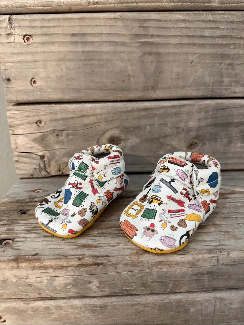 Freshly Picked “Friends” White Baby Moccasins with Multicolor Home Icons